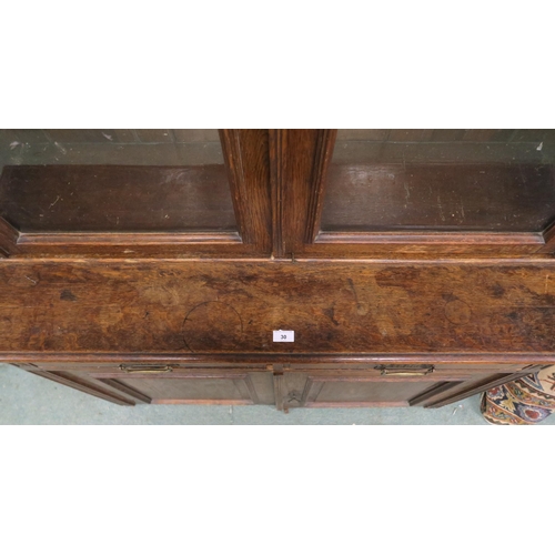 30 - A Victorian oak glazed bookcase with moulded cornice over pair of glazed doors over two drawers over... 