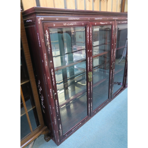 73 - A 20th century Oriental hardwood four door glazed bookcase, 111cm high x 183cm wide x 41cm deep