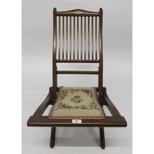 83 - An early 20th century mahogany framed comb back campaign chair with tapestry upholstered seat, 76cm ... 