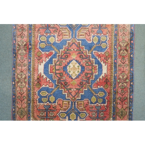 85 - A pink ground Hamadan rug with geometric central medallion, cream floral spandrels and multicoloured... 