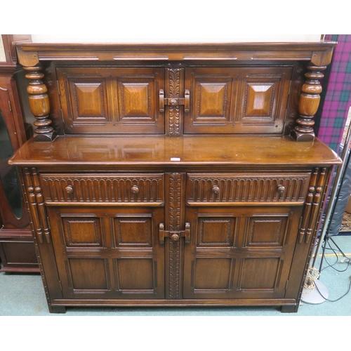 91 - A mid 20th century stained elm and beech court cabinet with pair of cabinet doors over two drawers o... 