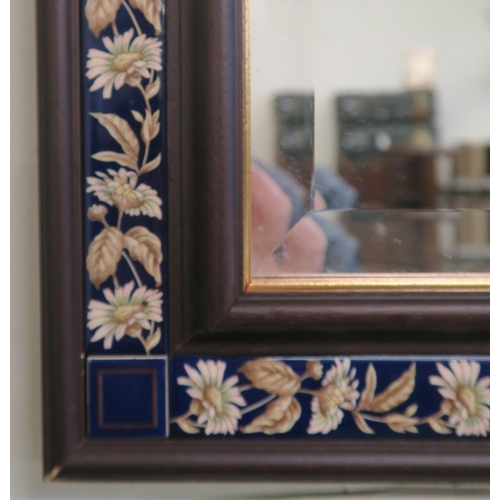 94 - A 20th century floral tiled framed bevelled glass wall mirror, two tier wall plate racks and a small... 