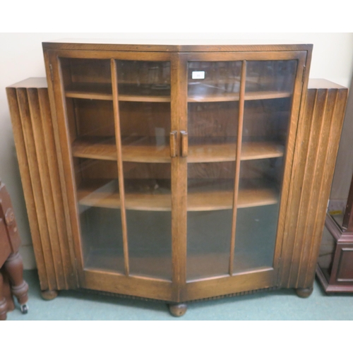 95 - An early 20th century Art Deco glazed two door bookcase with open bookcase ends, 112cm high x 122cm ... 