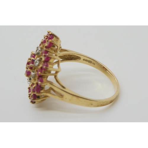 686 - A 9ct gold ruby and diamond cluster ring the diameter of the front is 19mm, finger size P1/2, weight... 