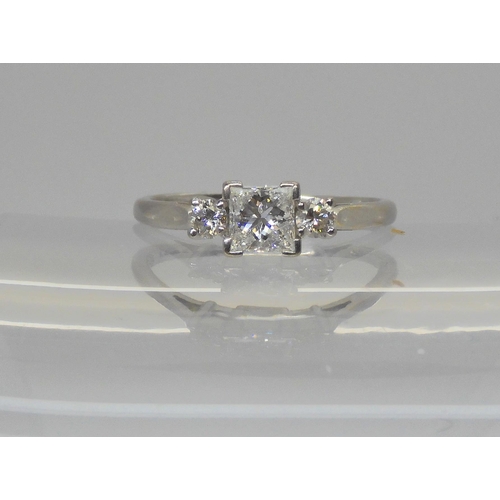 715 - An 18ct white gold princess cut and brilliant cut three stone diamond ring. Set with an estimated ap... 