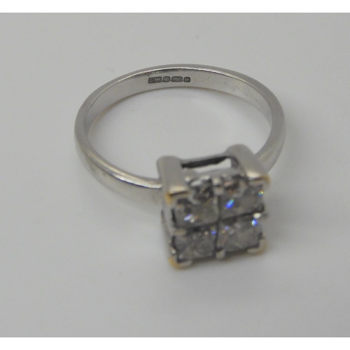 719 - An 18ct white gold four princess cut diamond cluster ring, set with estimated approx 0.80cts of diam... 