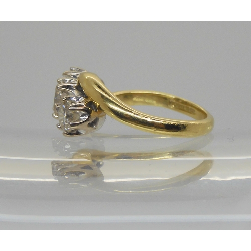 724 - An 18ct yellow and white gold classic three stone on a twist , set with estimated approx 1ct of bril... 
