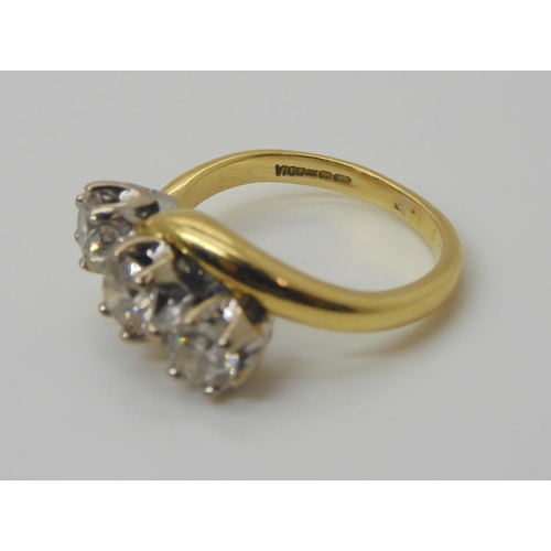 724 - An 18ct yellow and white gold classic three stone on a twist , set with estimated approx 1ct of bril... 