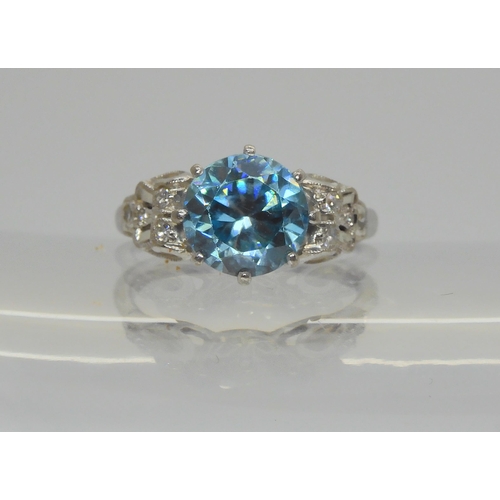 728 - An 18ct white gold blue zircon and diamond ring, the blue zircon measures 8.3mm, with eight cut diam... 