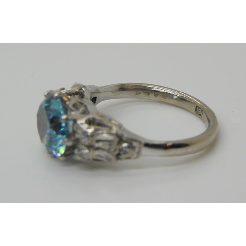 728 - An 18ct white gold blue zircon and diamond ring, the blue zircon measures 8.3mm, with eight cut diam... 