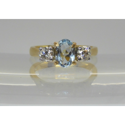 736 - An 18ct yellow gold aquamarine and diamond three stone ring, the central aqua measures 7mm x 5mm x 2... 