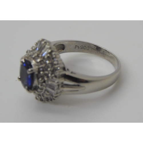 737 - A platinum sapphire and diamond cluster ring, the sapphire measures approx 6.6mm x 5.5mm x 3.2mm, fu... 