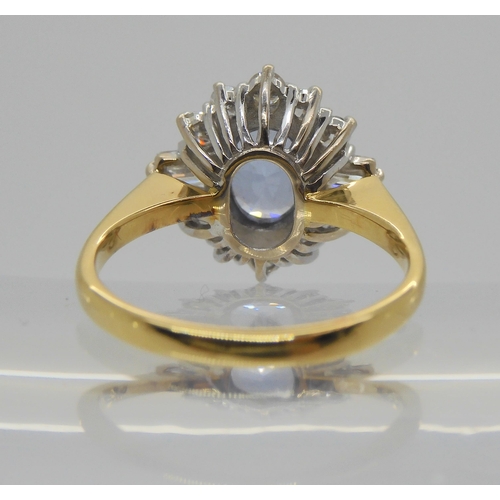 740 - An 18ct yellow and white gold cornflower blue sapphire and diamond cluster ring, set with a 8mm x 6m... 