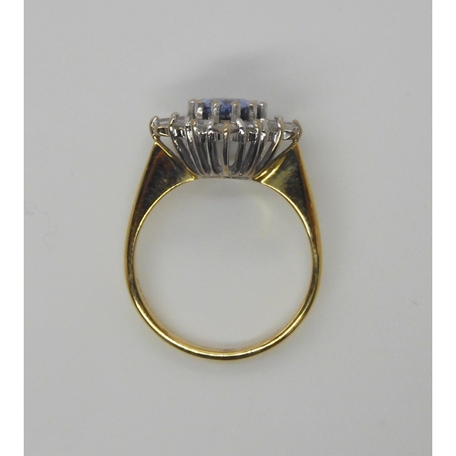 740 - An 18ct yellow and white gold cornflower blue sapphire and diamond cluster ring, set with a 8mm x 6m... 
