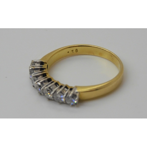 749 - An 18ct gold seven stone diamond ring, set with estimated approx 0.75cts of brilliant cut diamonds, ... 