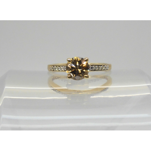 751 - A 9ct gold champagned diamond solitaire of estimated approx 1ct with further white diamond accents t... 