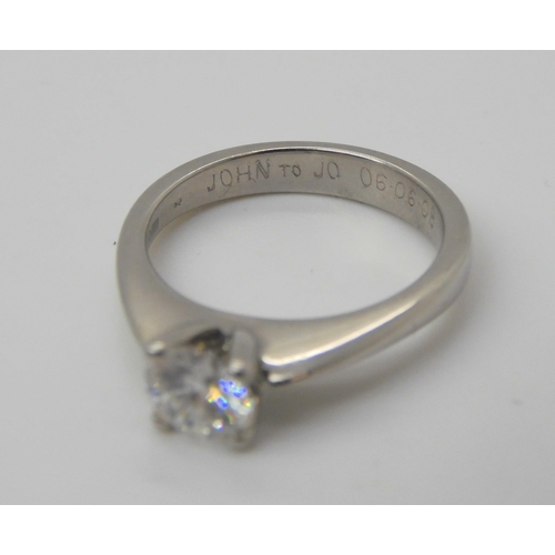 753 - A platinum diamond solitaire, set with an estimated approx 0.60ct brilliant cut diamond, size L, wit... 
