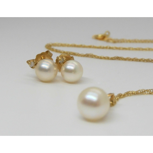 763 - A 14k pearl and diamond accent pendant with matching earrings, length of the chain 46cm, weight 1.8g... 