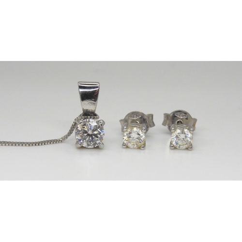 766 - A 14k white gold diamond solitaire pendant of estimated approx 0.50cts, together with a pair of matc... 