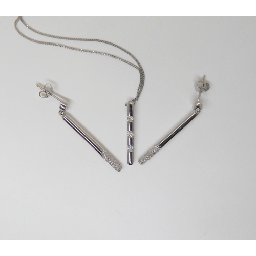 770 - A 9ct white gold diamond baton, pendant and matching earrings, set with estimated approx 0.10cts of ... 