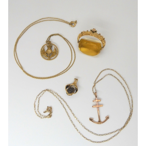 775 - A 9ct mounted amber glass fob, a 9ct thistle pendant on chain, a 9ct rose gold anchor pendant on cha... 