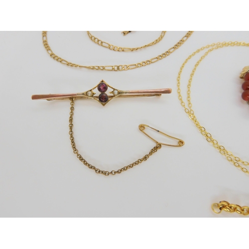 783 - A 9ct citrine ring, set at an angle, a 9ct garnet and seed pearl bar brooch, 9ct mounted citrine pen... 