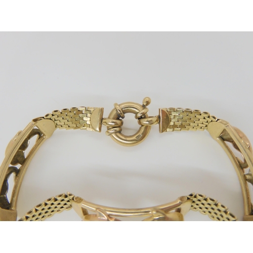 786 - A 9ct yellow gold bracelet with tri coloured gold dolphin links, 17.8gms