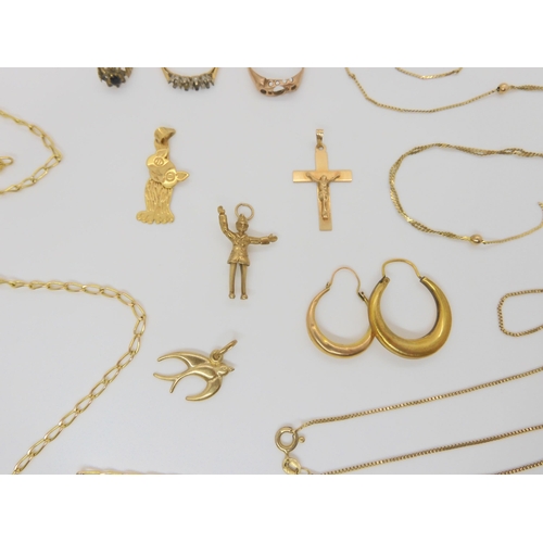 789 - A collection of 9ct gold and yellow metal items including policeman charm, cross pendant, swallow pe... 