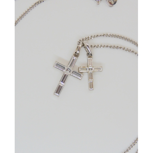 799 - An 18ct white gold diamond mounted cross, another smaller, both on a 9ct white gold chain