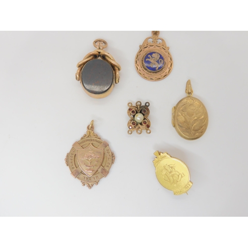 804 - Three 9ct medals, a gem and pearl set clasp, a 9ct locket and a 9ct mounted bloodstone and carnelian... 