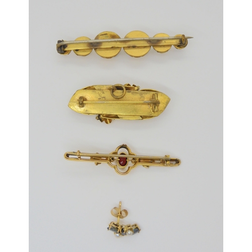 813 - A 9ct red gem set bar brooch, two yellow metal brooches and a gem set earring, weight together ... 