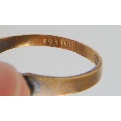 821 - A 15ct coral, seed pearl and diamond set ring, a 9ct citrine set ring, and a 9ct gold bangle