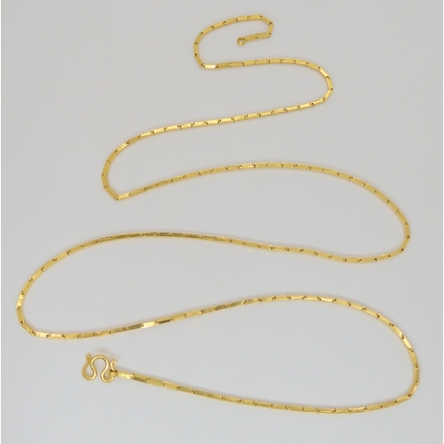 834 - A yellow metal neck chain with indistinct marks, 35cm long, with S scroll catch, 15.2gms