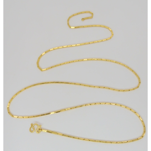 834 - A yellow metal neck chain with indistinct marks, 35cm long, with S scroll catch, 15.2gms