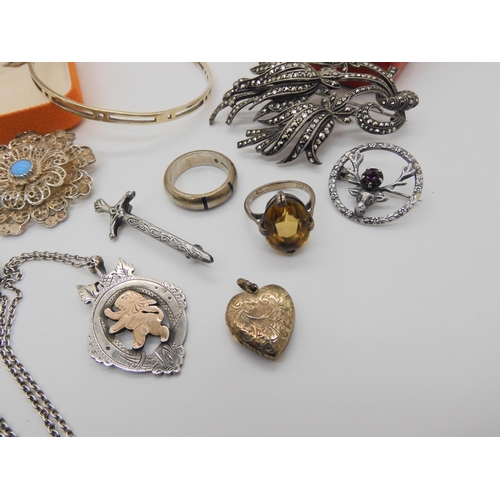 857 - Two silver chess medallions, a yellow metal heart shaped locket, a large marcasite brooch and other ... 