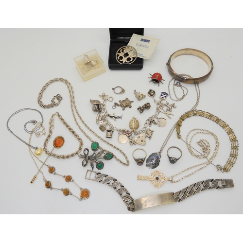 874 - A silver charm bracelet, with attached and loose, silver and white metal charms and other items