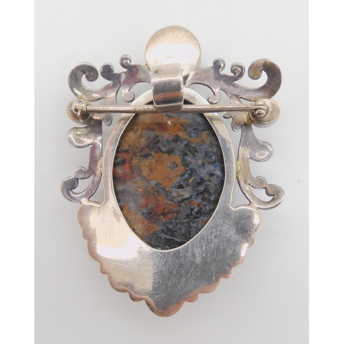 891 - A silver pendant brooch set with star rubies and a large blue and gold tigers eye specimen stone cal... 