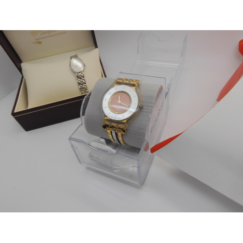 896 - A Swatch watch with three coloured golden strap and mirrored dial in original packaging, together wi... 