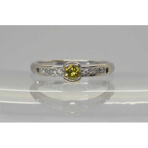 762A - An 18ct white gold yellow diamond ring of estimated approx 0.20cts with further diamond accents to t... 
