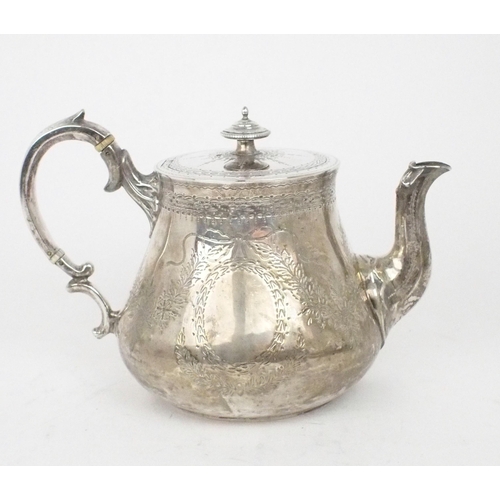 2458 - A VICTORIAN SILVER TEAPOTof swollen cylindrical form, the body with engraved floral decoration, the ... 