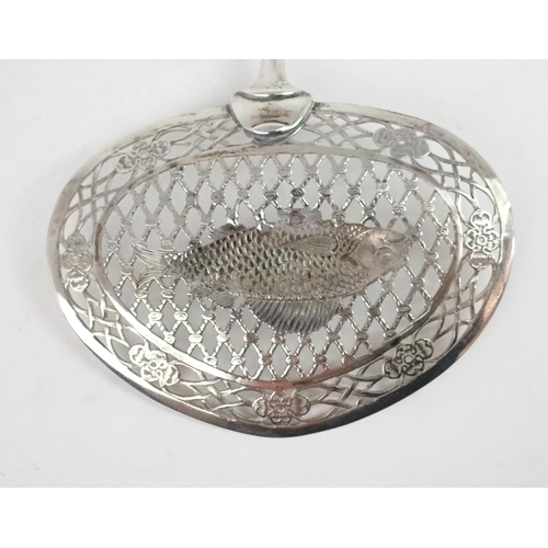 2462 - A DUTCH SILVER FISH SLICEthe bowl of reticulated oval form resembling a fish caught in a net, surrou... 