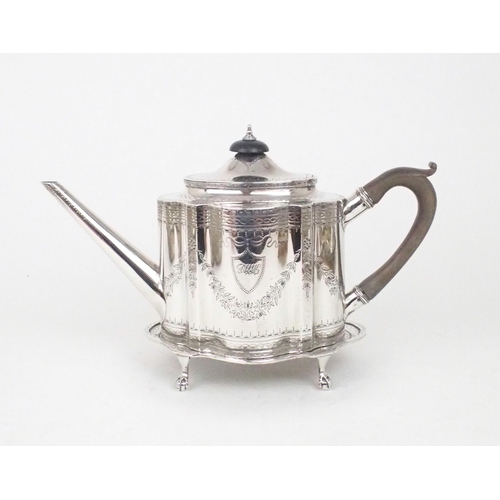 2465 - A GEORGE III SCOTTISH SILVER TEAPOT AND STANDof shaped oval form, the body bright-engraved with flor... 