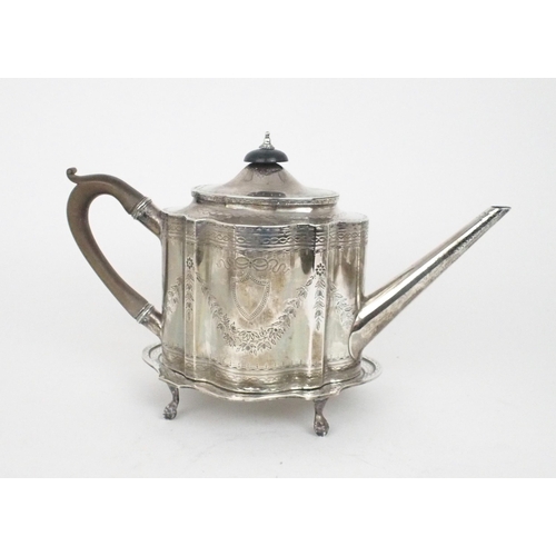 2465 - A GEORGE III SCOTTISH SILVER TEAPOT AND STANDof shaped oval form, the body bright-engraved with flor... 