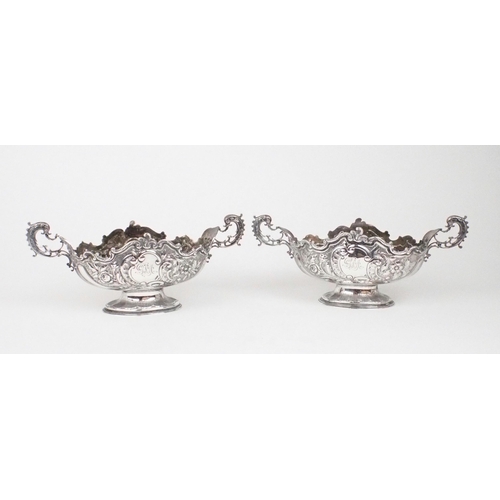 2469 - A PAIR OF EDWARDIAN SILVER FRUIT BOWLSof oval form, the bodies with chased and repousse scrolling fo... 