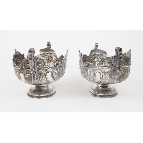 2469 - A PAIR OF EDWARDIAN SILVER FRUIT BOWLSof oval form, the bodies with chased and repousse scrolling fo... 