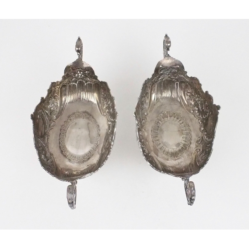 2469 - A PAIR OF EDWARDIAN SILVER FRUIT BOWLSof oval form, the bodies with chased and repousse scrolling fo... 