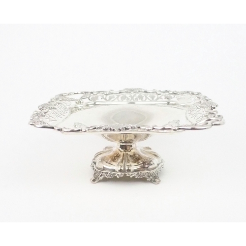 2470 - AN EDWARDIAN SILVER TAZZAof square form, with a cast openwork scrolling foliate rim, the two corners... 