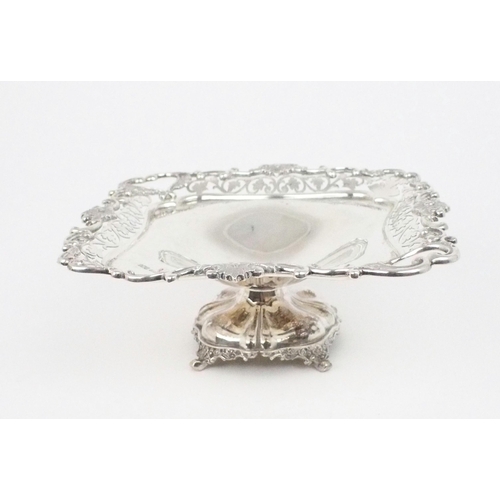 2470 - AN EDWARDIAN SILVER TAZZAof square form, with a cast openwork scrolling foliate rim, the two corners... 