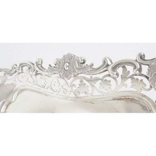 2470 - AN EDWARDIAN SILVER TAZZAof square form, with a cast openwork scrolling foliate rim, the two corners... 