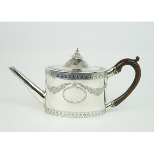 2476 - A GEORGE III SILVER TEAPOTof oval form, the body with engraved floral swags and fleur de lys banding... 